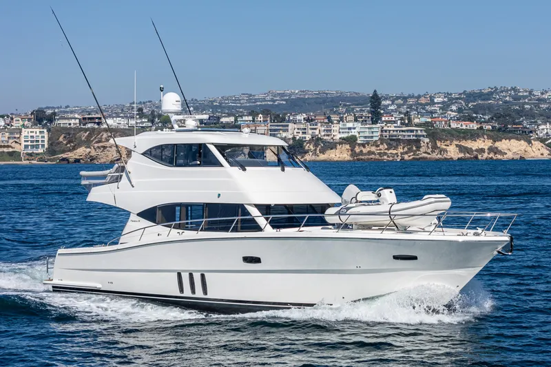 True North Yacht Photos Pics 2020 Maritimo M59 yacht cruising near coastal cityscape.