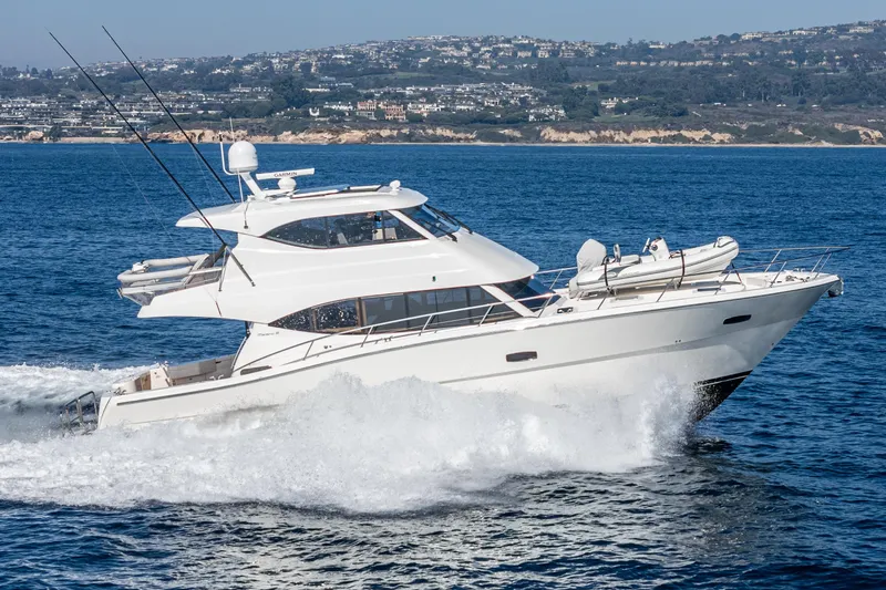 True North Yacht Photos Pics 2020 Maritimo M59 yacht cruising on the ocean with coastal background.