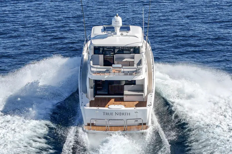 True North Yacht Photos Pics 2020 Maritimo M59 yacht cruising on open water, rear view.