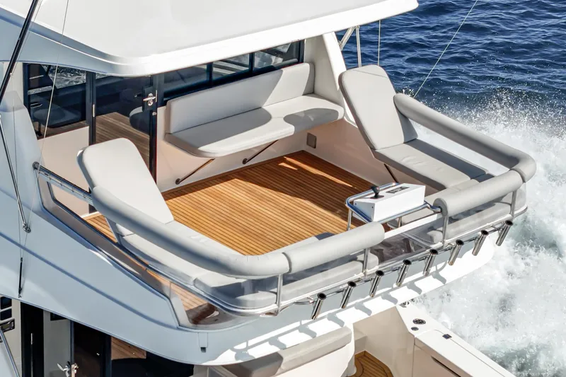 True North Yacht Photos Pics Luxury Maritimo M59 yacht deck, 2020 model, with elegant seating and ocean backdrop.