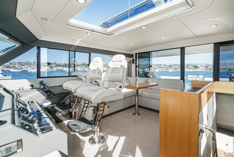 True North Yacht Photos Pics Luxurious interior of 2020 Maritimo M59 yacht with panoramic windows and plush seating.