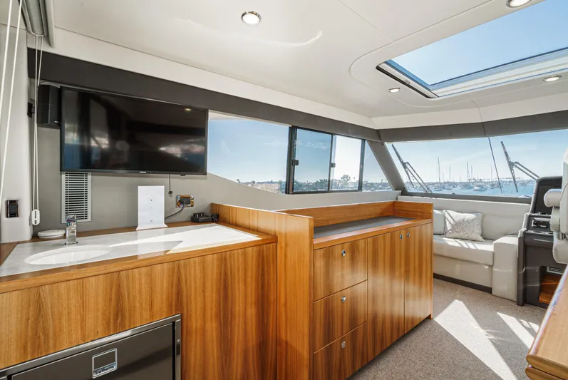 True North Yacht Photos Pics Luxurious interior of 2020 Maritimo M59 yacht with wood cabinetry and large windows.