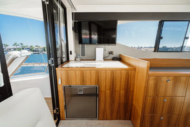 True North Yacht Photos Pics Interior of 2020 Maritimo M59 yacht with wooden cabinetry and waterfront view.