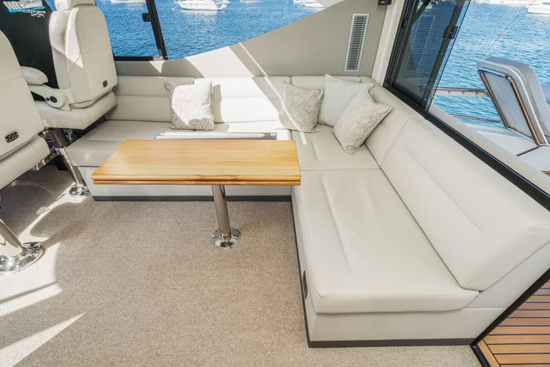 True North Yacht Photos Pics Luxurious interior of 2020 Maritimo M59 yacht with plush seating and wooden table.