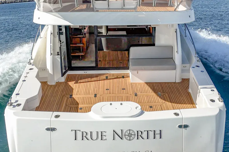 True North Yacht Photos Pics 2020 Maritimo M59 yacht with spacious deck, cruising on open water.