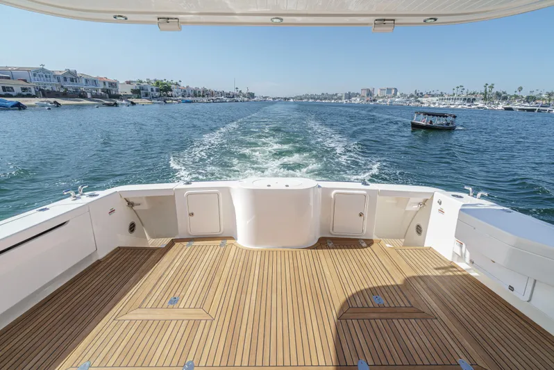 True North Yacht Photos Pics Maritimo M59 yacht deck with ocean view, 2020 model, cruising in a scenic harbor.