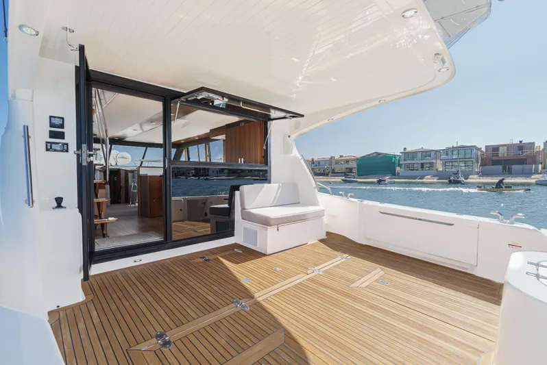 True North Yacht Photos Pics 2020 Maritimo M59 yacht deck with seating, overlooking waterfront homes.