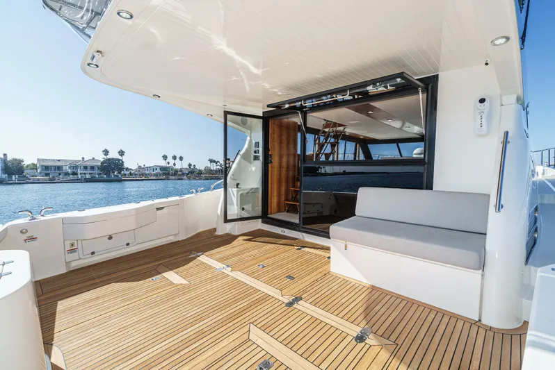 True North Yacht Photos Pics 2020 Maritimo M59 yacht deck with seating, overlooking waterfront homes.