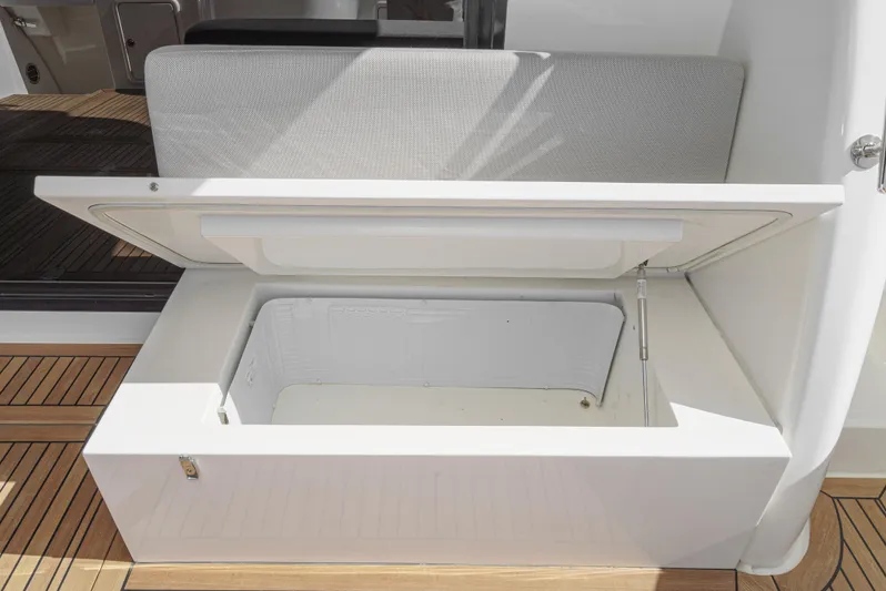 True North Yacht Photos Pics Open storage compartment on 2020 Maritimo M59 yacht, featuring sleek design and wooden deck.