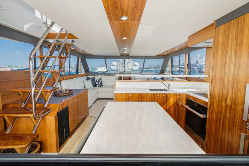 True North Yacht Photos Pics Luxurious interior of 2020 Maritimo M59 yacht with modern kitchen and seating area.