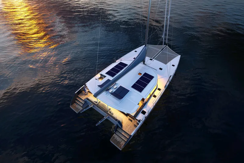  Yacht Photos Pics Modern Balance 750 catamaran sailing at sunset, featuring solar panels and illuminated deck, 2027 model.
