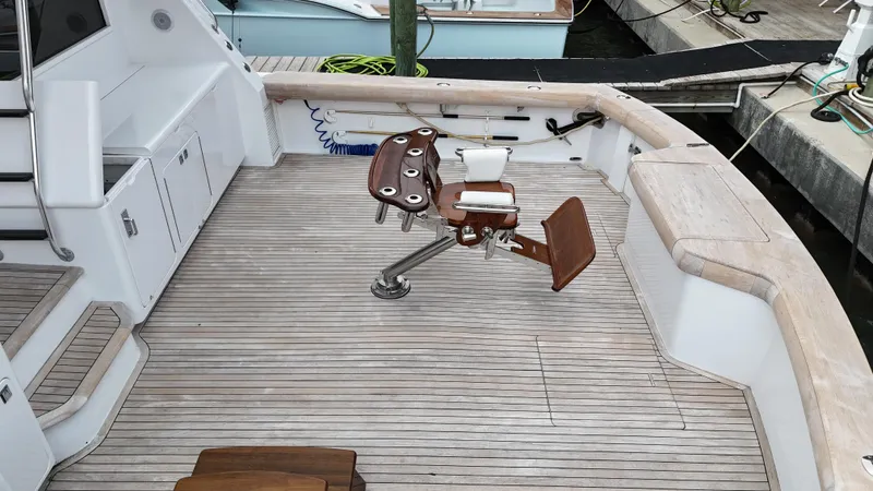 Poco Mas Yacht Photos Pics 1996 Donzi Custom Enclosed Flybridge boat deck with fishing chair.