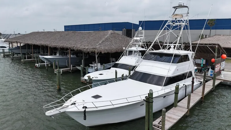 Poco Mas Yacht Photos Pics 1996 Donzi Custom Enclosed Flybridge yacht docked at marina.