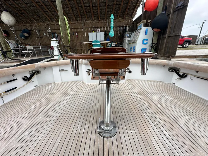 Poco Mas Yacht Photos Pics 1996 Donzi Custom Enclosed Flybridge deck with fishing chair and rod holders.