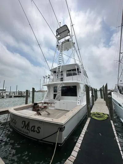 Poco Mas Yacht Photos Pics 1996 Donzi Custom Enclosed Flybridge yacht docked at marina under cloudy sky.