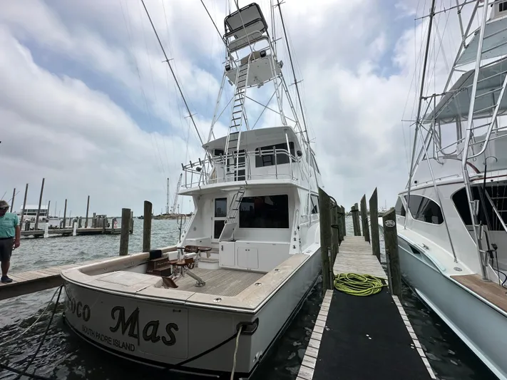 Poco Mas Yacht Photos Pics 1996 Donzi Custom Enclosed Flybridge yacht docked at marina.