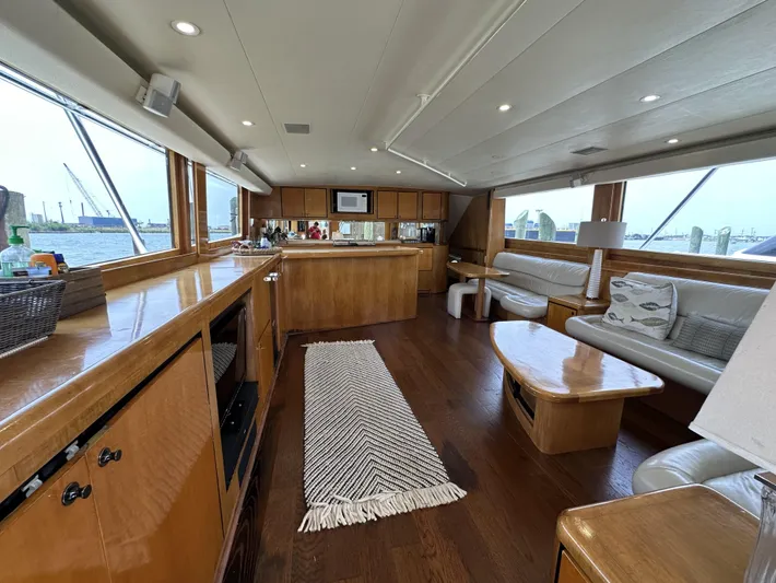 Poco Mas Yacht Photos Pics 1996 Donzi Custom Enclosed Flybridge interior with wooden cabinetry and panoramic windows.