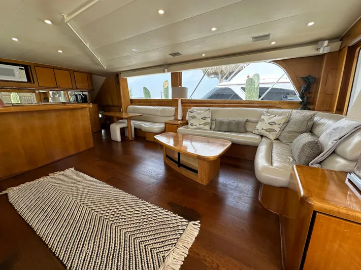 Poco Mas Yacht Photos Pics Luxurious interior of a 1996 Donzi Custom Enclosed Flybridge yacht with wooden finishes.