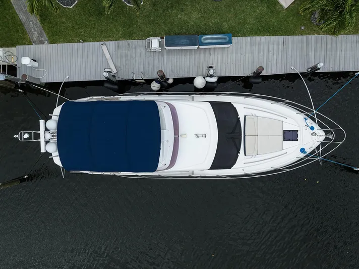  Yacht Photos Pics Aerial view of 2022 Princess F50 yacht docked at a wooden pier.