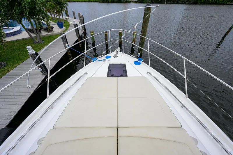  Yacht Photos Pics 2022 Princess F50 yacht bow view at dock, featuring spacious sunbathing area.