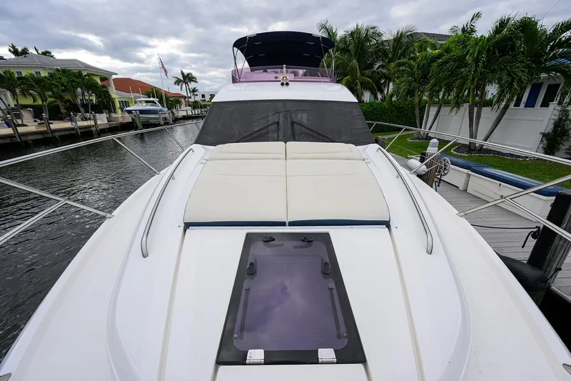  Yacht Photos Pics 2022 Princess F50 yacht docked by palm trees and waterfront homes.