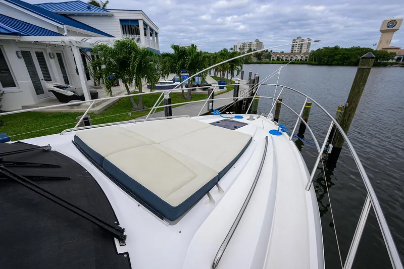  Yacht Photos Pics 2022 Princess F50 yacht docked by a waterfront home.