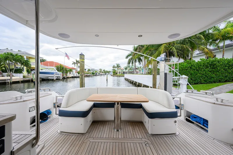  Yacht Photos Pics Luxury yacht Princess F50 2022 with elegant deck seating and scenic waterfront view.