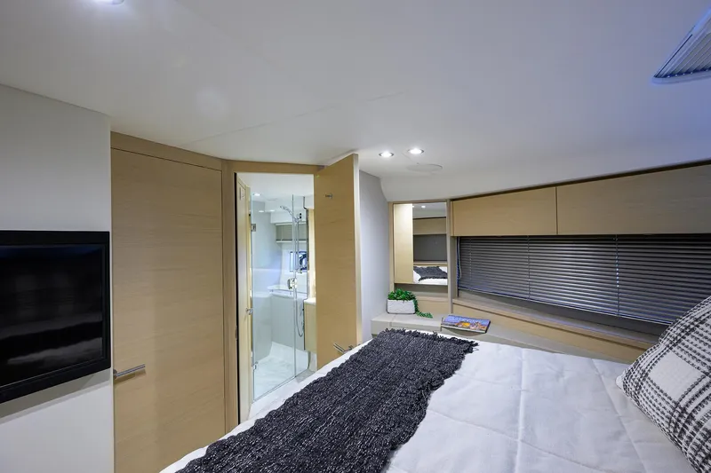  Yacht Photos Pics Luxurious interior of 2022 Princess F50 yacht with modern bedroom and ensuite bathroom.