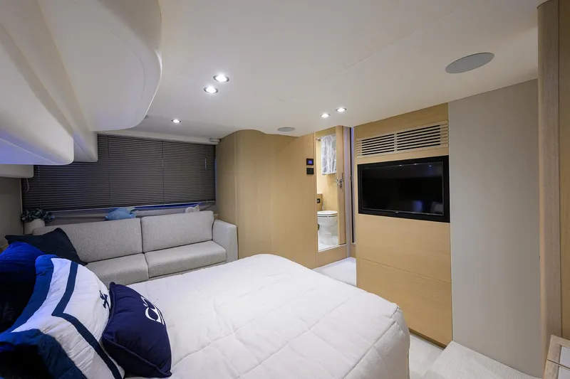  Yacht Photos Pics Luxurious 2022 Princess F50 yacht bedroom with modern decor and cozy seating area.