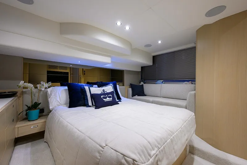  Yacht Photos Pics Luxurious 2022 Princess F50 yacht bedroom with elegant decor and cozy bedding.