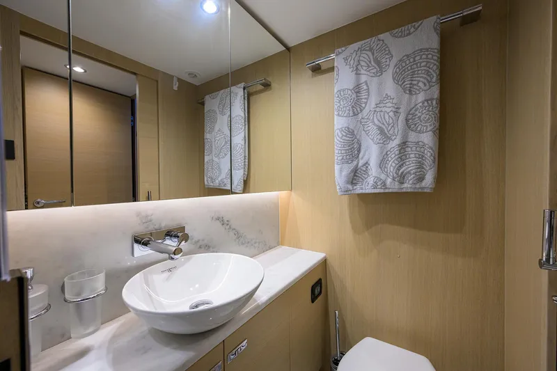  Yacht Photos Pics Luxurious bathroom in 2022 Princess F50 yacht with modern fixtures and elegant design.