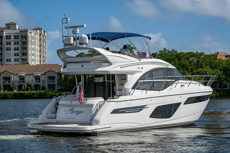  Yacht Photos Pics Luxury 2022 Princess F50 yacht cruising on a scenic waterway.