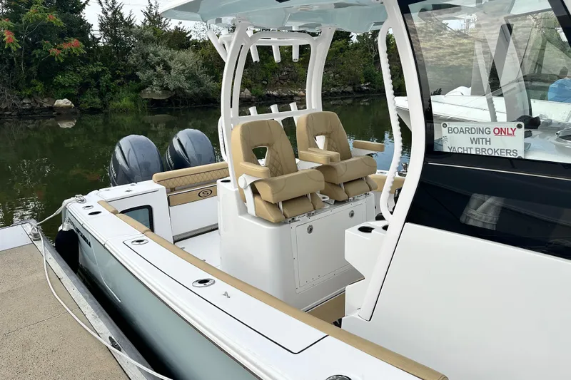  Yacht Photos Pics 2023 Sportsman Open 282 Center Console boat docked, featuring dual engines and tan seating.