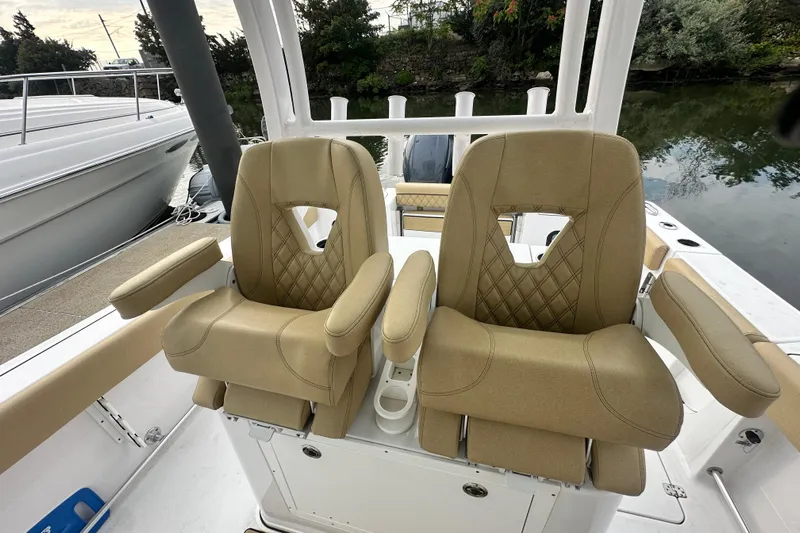 Yacht Photos Pics 2023 Sportsman Open 282 Center Console with tan cushioned seats, docked by water.