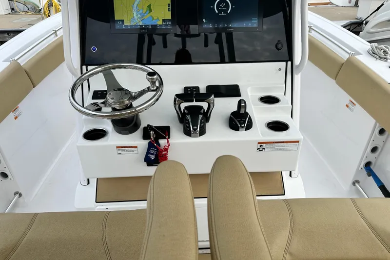  Yacht Photos Pics 2023 Sportsman Open 282 Center Console dashboard with steering wheel and navigation display.