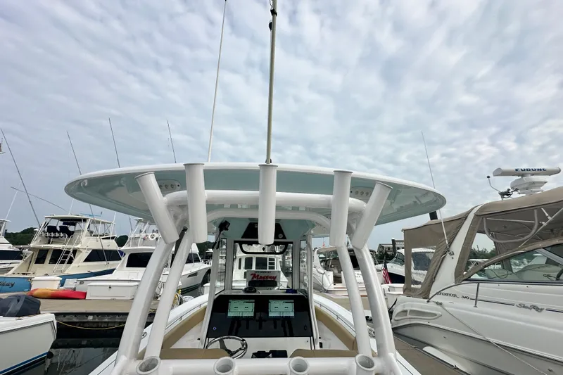  Yacht Photos Pics 2023 Sportsman Open 282 Center Console boat docked at marina under cloudy sky.