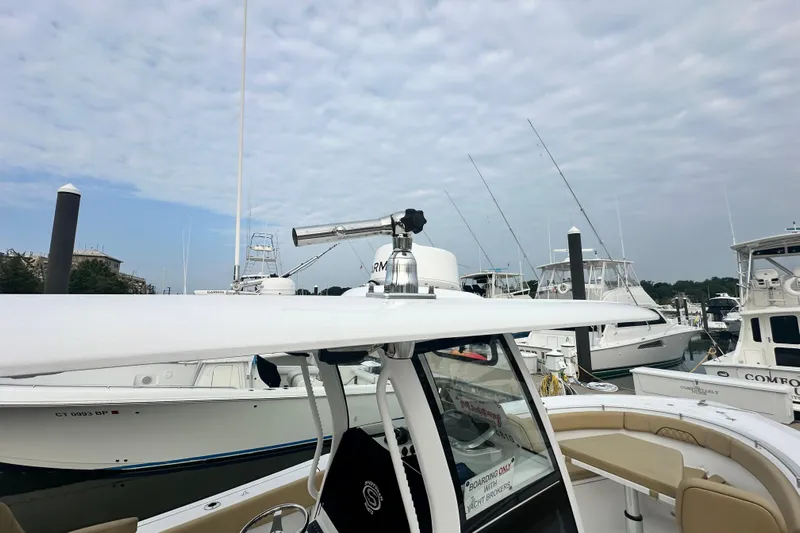  Yacht Photos Pics 2023 Sportsman Open 282 Center Console boat docked at marina with clear sky.