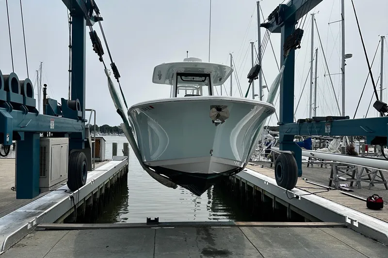  Yacht Photos Pics 2023 Sportsman Open 282 Center Console boat in a marina lift.