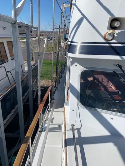 Duc De Kent Yacht Photos Pics 1985 Custom Cape Island Trawler 43 docked, showcasing side deck and cabin details.