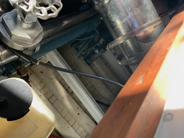 Duc De Kent Yacht Photos Pics Engine compartment of 1985 Custom Cape Island Trawler 43, showing pipes and mechanical components.