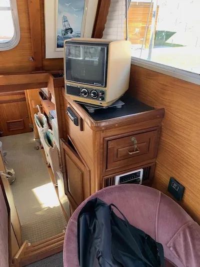 Duc De Kent Yacht Photos Pics Vintage interior of 1985 Cape Island Trawler 43 with retro TV and wooden cabinetry.
