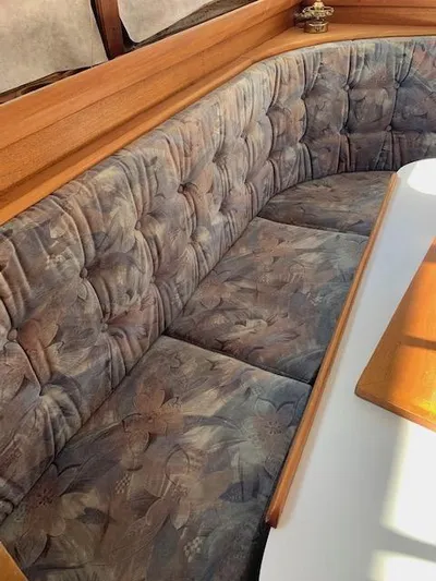 Duc De Kent Yacht Photos Pics Plush seating in 1985 Custom Cape Island Trawler 43 with wooden accents and table.
