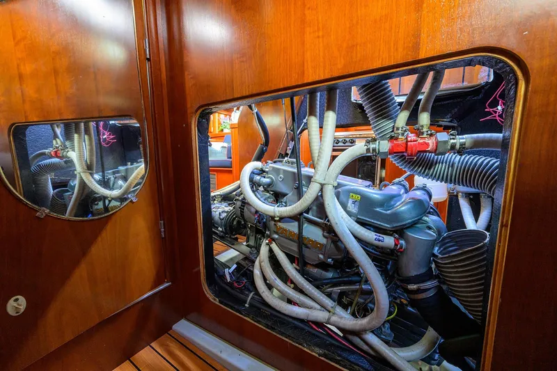 Windigo Yacht Photos Pics Engine room of a 2003 Beneteau 50 yacht, showcasing complex machinery and hoses.