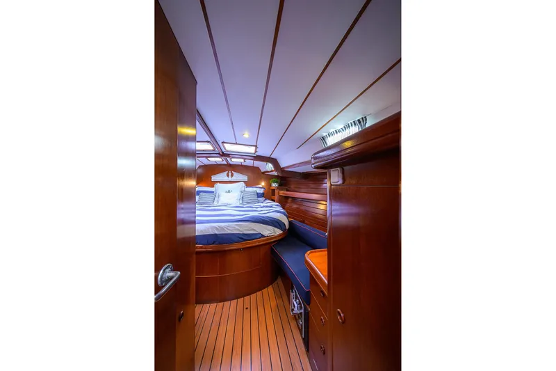 Windigo Yacht Photos Pics Luxurious cabin interior of 2003 Beneteau 50 yacht with wooden finish and cozy bed.
