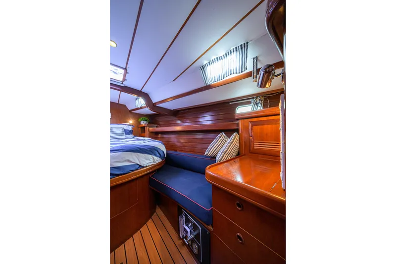 Windigo Yacht Photos Pics Luxurious cabin interior of 2003 Beneteau 50 yacht with wood finish and cozy bedding.
