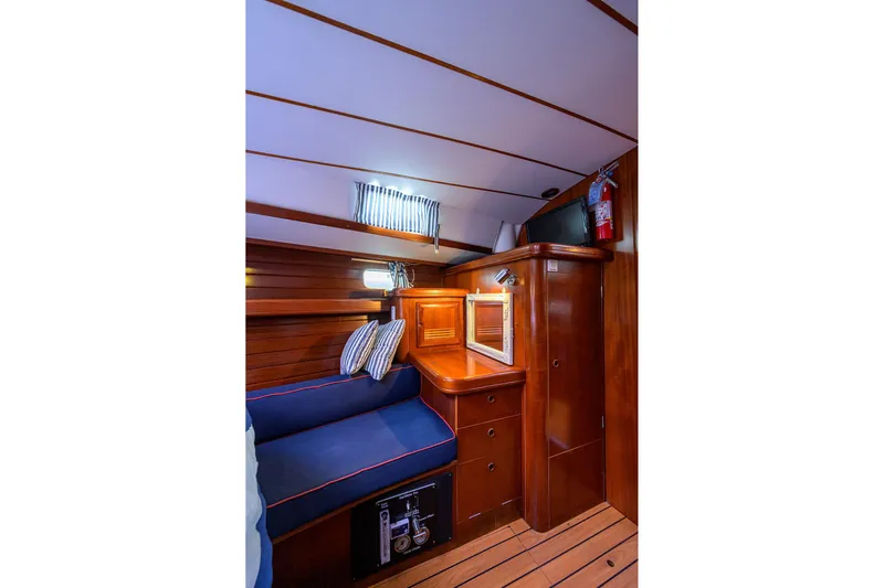 Windigo Yacht Photos Pics Cozy cabin interior of 2003 Beneteau 50 yacht with wooden finish and seating area.