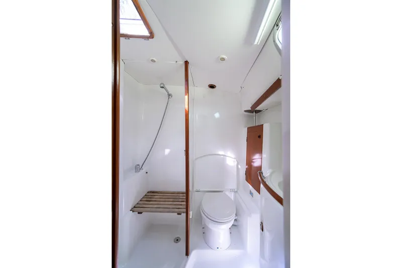 Windigo Yacht Photos Pics Bathroom interior of 2003 Beneteau 50 yacht, featuring shower and toilet.