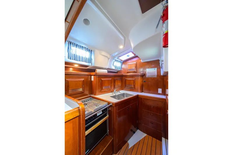 Windigo Yacht Photos Pics Luxurious 2003 Beneteau 50 yacht kitchen with wood cabinetry and modern appliances.
