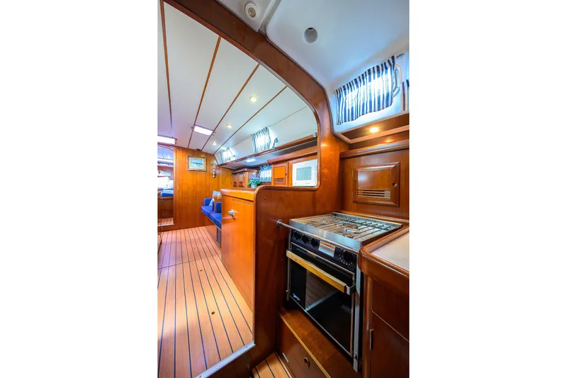 Windigo Yacht Photos Pics Interior of 2003 Beneteau 50 yacht with wooden finish and modern kitchen amenities.