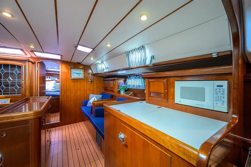 Windigo Yacht Photos Pics Luxurious interior of 2003 Beneteau 50 yacht with wood finish and modern amenities.